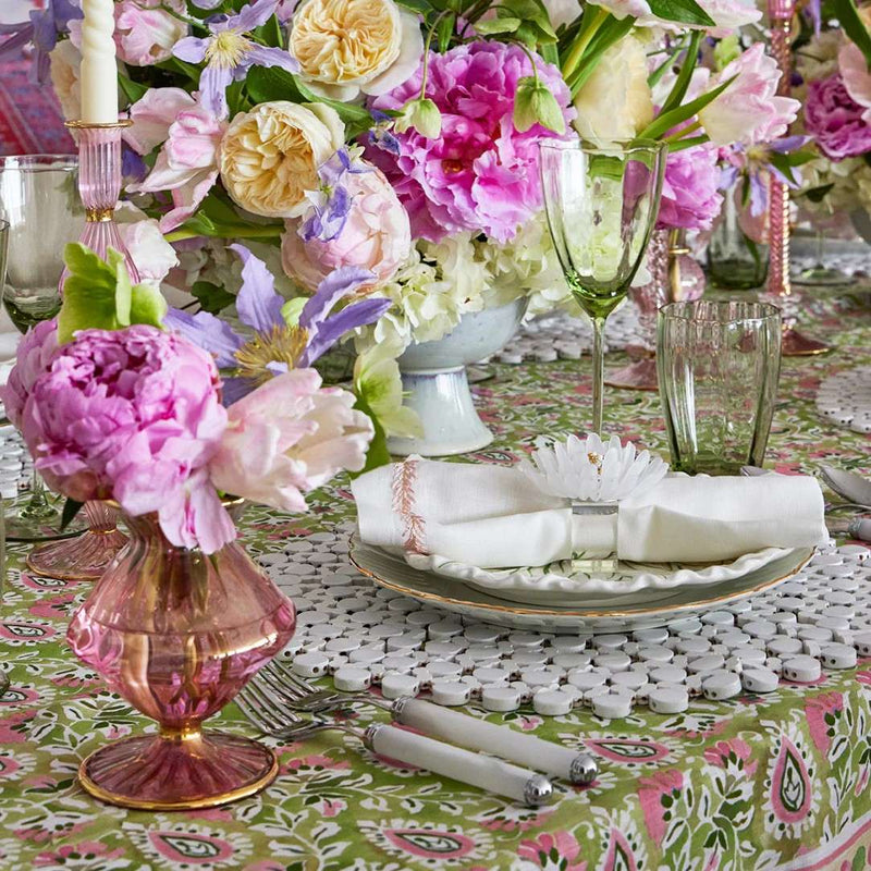 Luxury white round bamboo placemat with organic texture by Kim Seybert side view on floral table setting.