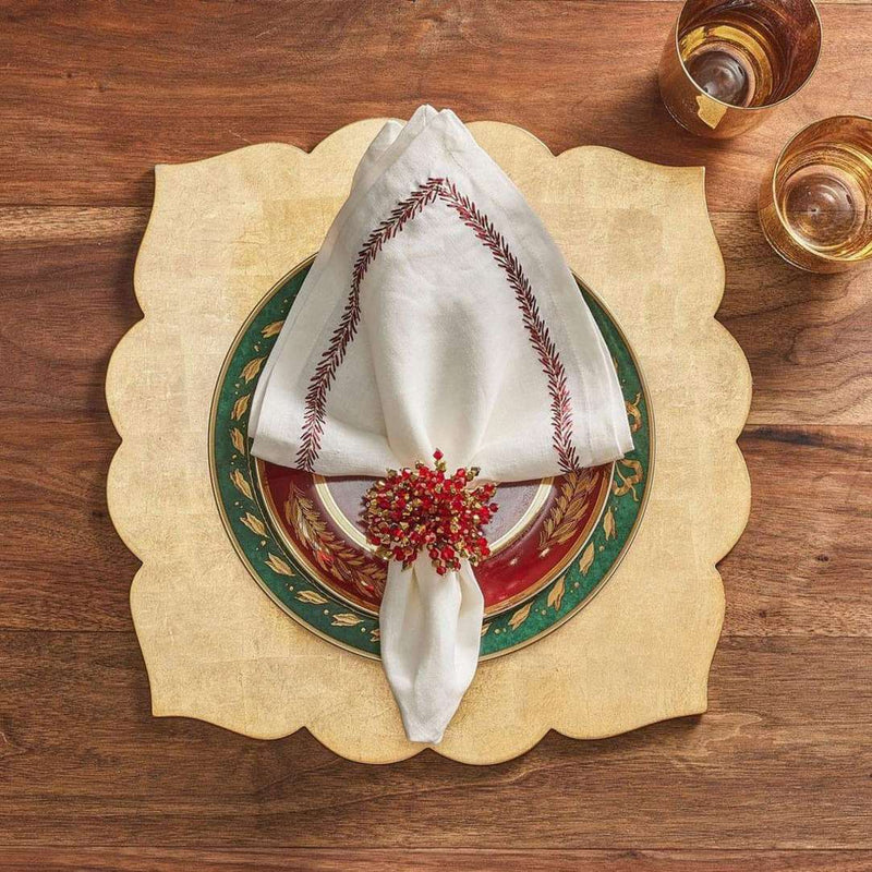 Champagne-gold Fez placemat with lacquer finish by Kim Seybert styled with red napkin ring