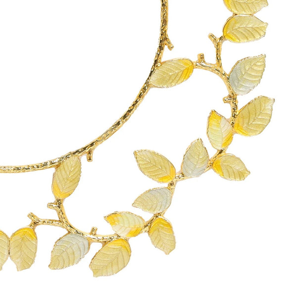 Gold and silver enamel charger with leaf motif by Kim Seybert close-up.