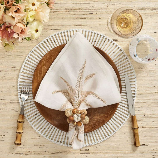 White spoke bamboo placemats by Kim Seybert, luxury tableware styled with a palm tree napkin.