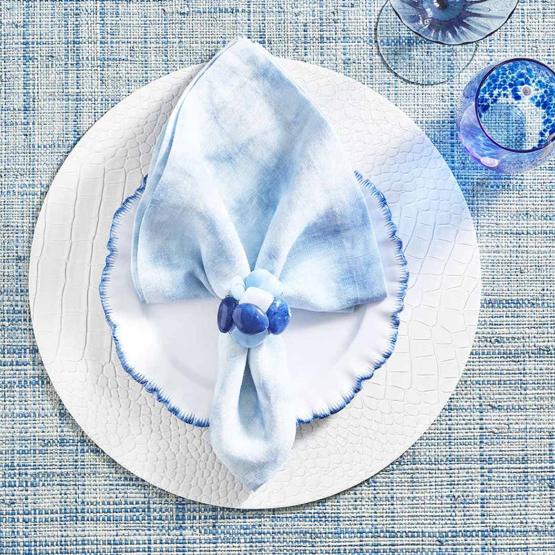 White croco placemat with embossed texture by Kim Seybert styled on blue mediteranean tablescape