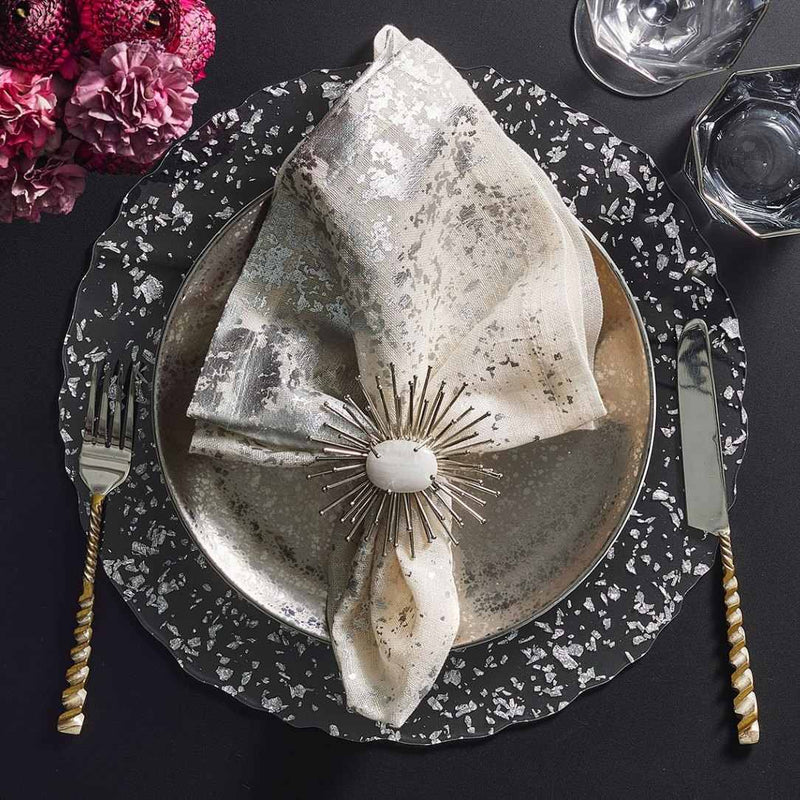 Clear acrylic placemat with silver flecks and wavy edge by Kim Seybert with silver napkin.