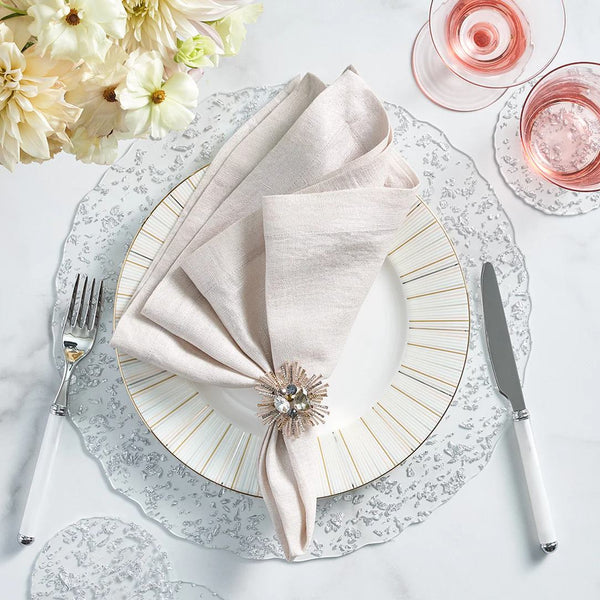 Clear acrylic placemat with silver flecks and wavy edge by Kim Seybert styled on elegant tablescape.
