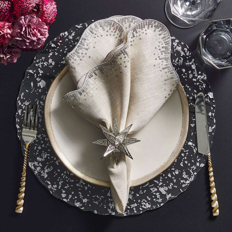Clear acrylic placemat with silver flecks and wavy edge by Kim Seybert styled with silver napkin ring.