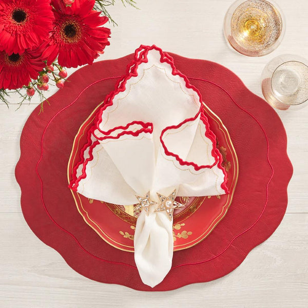 Oval ruby placemat with wavy edge luxury dining accessory on festive luxury tablescape.