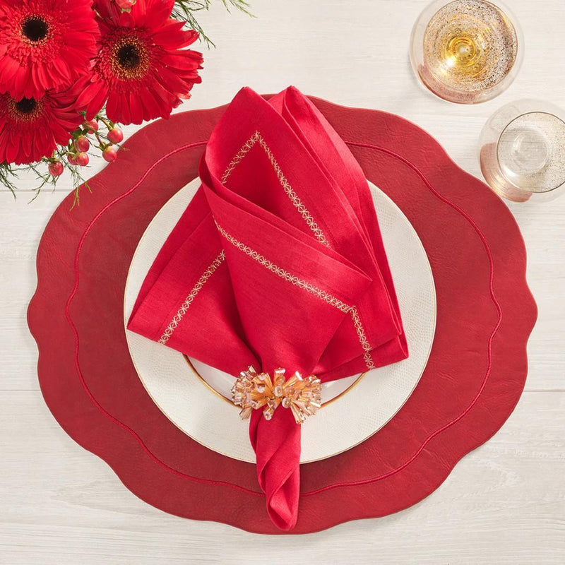 Oval ruby placemat with wavy edge luxury dining accessory on red tablescape.