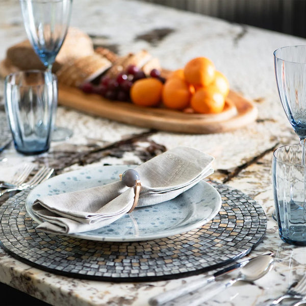 Gray and taupe shell placemat with ombre mosaic design on modern luxe tablescape.