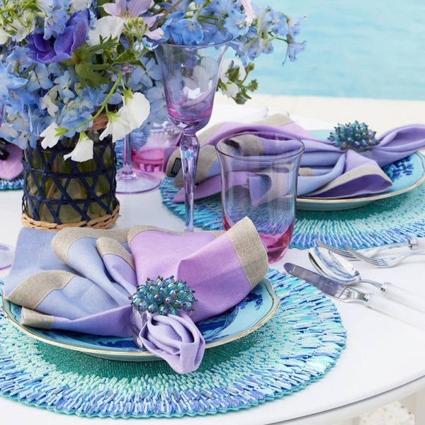 Periwinkle and seafoam beaded ombre placemat with radiant sequins on luxury pool tablescape.