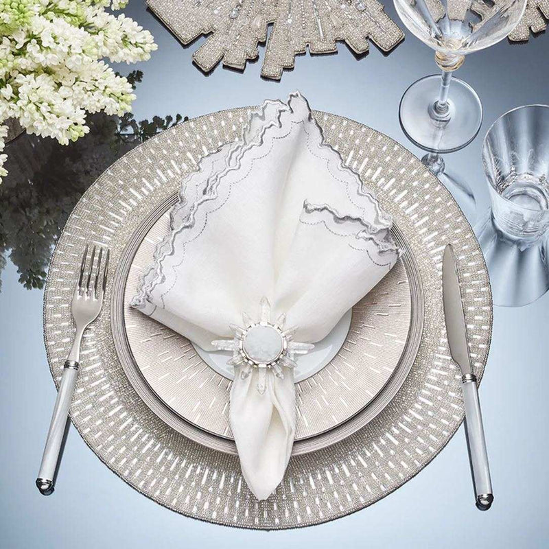 Palisade beaded placemat and crystal beaded border in silver by Kim Seybert on luxury table setting.