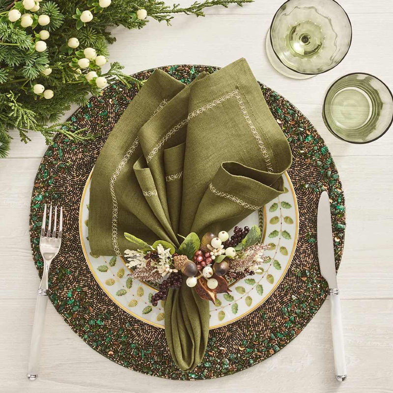 Green and gold beaded placemat with by Kim Seybert with fall autumnal napkin ring.