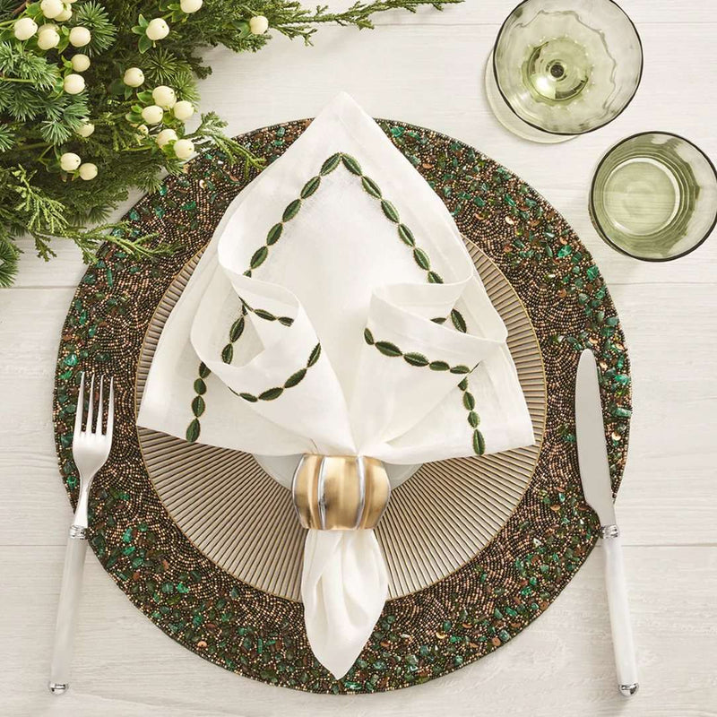 Green and gold beaded placemat with by Kim Seybert with gold napkin ring.