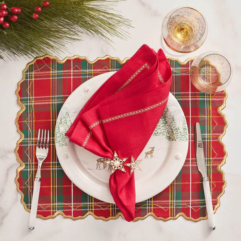 Red tartan placemat with gold embroidered scalloped edge with stars gold napkin ring.