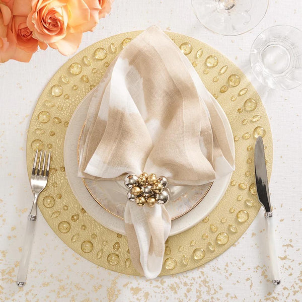 Gold Dew Drops placemat with resin gemstone border by Kim Seybert styled on modern luxurious tablescape.