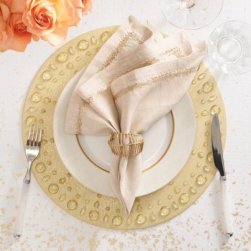 Gold Dew Drops placemat with resin gemstone border by Kim Seybert styled with tupe napkin.