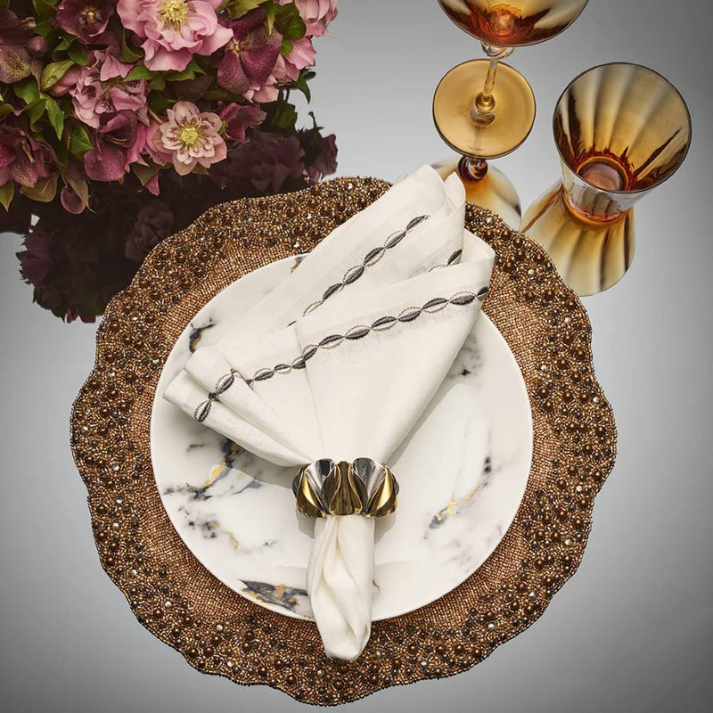 Kim Seybert Enigma placemat in gold and gunmetal beads styled with odern metalic napkin ring.