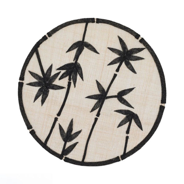 Black straw placemat with bamboo motif by Joanna Buchanan.