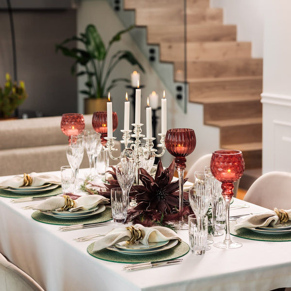 Green basket-weave placemat with layered tones on elegant candle light tablescape.