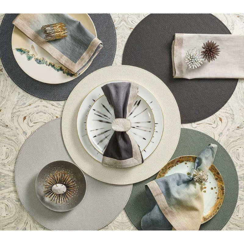 Grey faux shagreen placemat with textured finish by Kim Seybert in different colour variations.