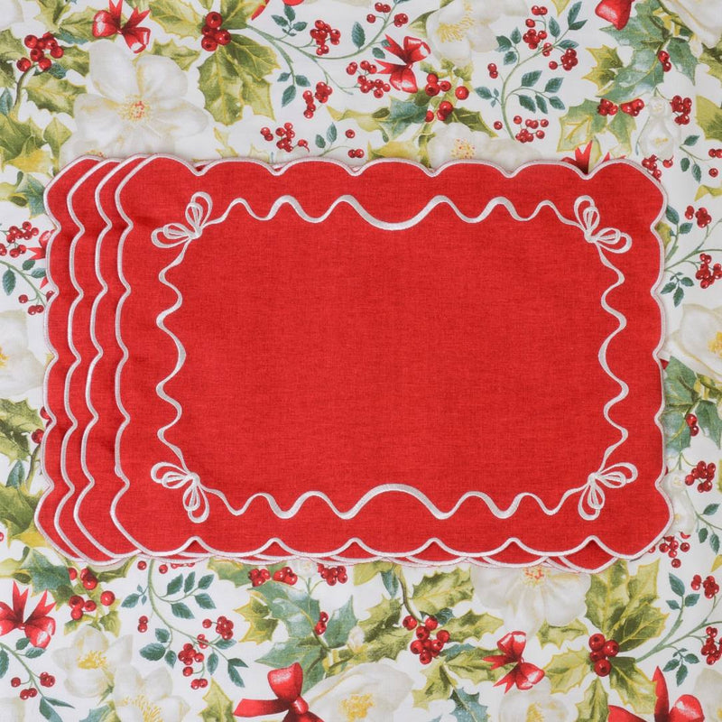 Red cotton placemat embroidered with white Christmas bows in set of six.