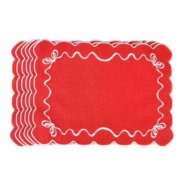 Red cotton placemat embroidered with white Christmas bows by Roseberry Home.