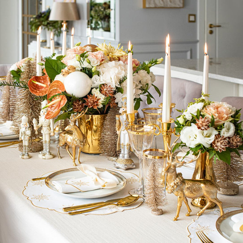 White cotton placemat with gold star embroidery by Roseberry Home on festive gold tablescape.