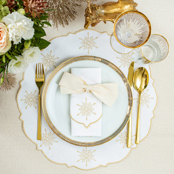 White cotton placemat with gold star embroidery by Roseberry Home on Christmas tablescape.
