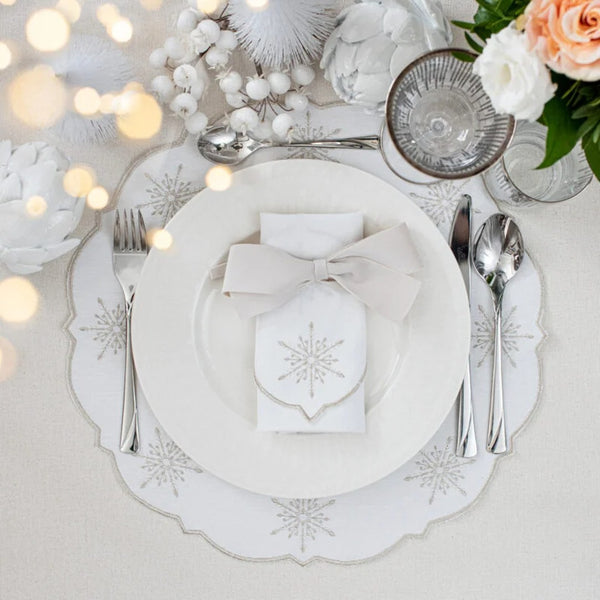 Round cotton placemat with silver star embroidery by Roseberry Home styled on Christmas tablescape.