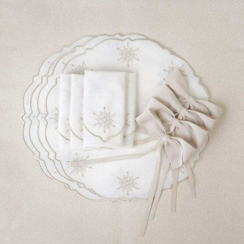Round cotton placemat with silver star embroidery by Roseberry Home with matching napkins and bows.