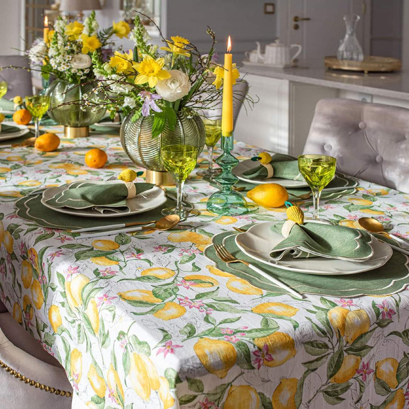 Emerald green embroidered placemats with petal shape on lemon themed tablescape.