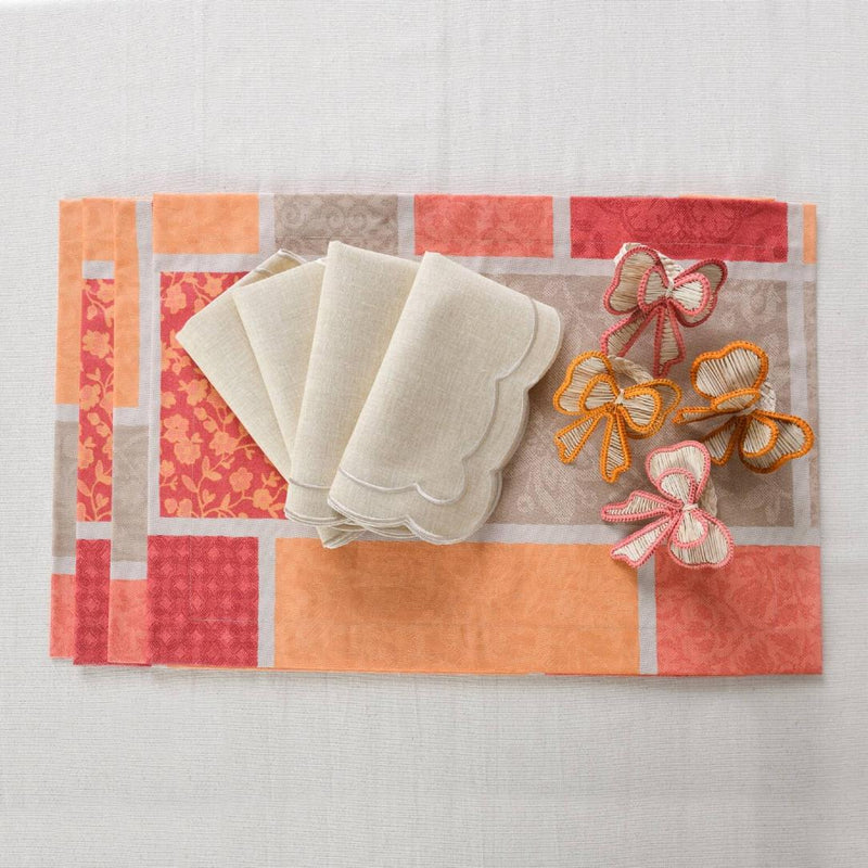 Orange cotton placemat with acrylic coating with matching napkins and bows.