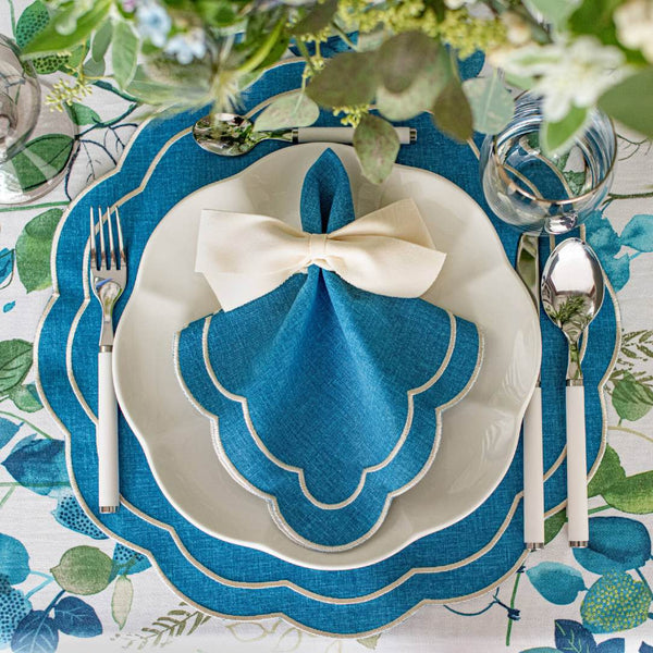 Blue Petali embroidered placemats in Italian fabric styled with white ribbon napkin ring.