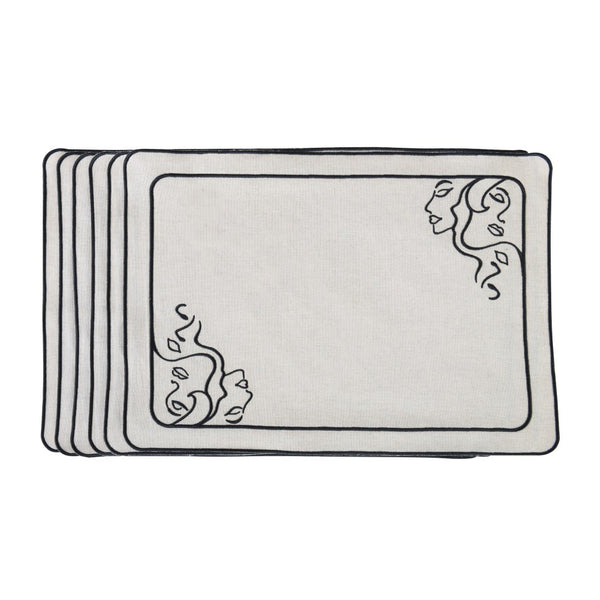 Beige fabric placemat with embroidered female face motifs by Roseberry Home.