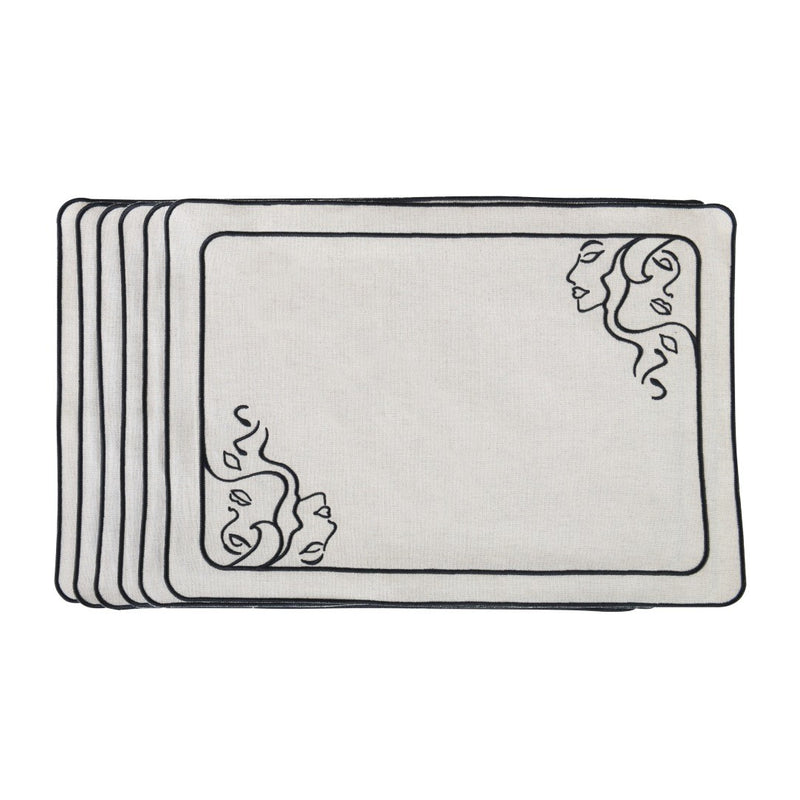 Beige fabric placemat with embroidered female face motifs by Roseberry Home.