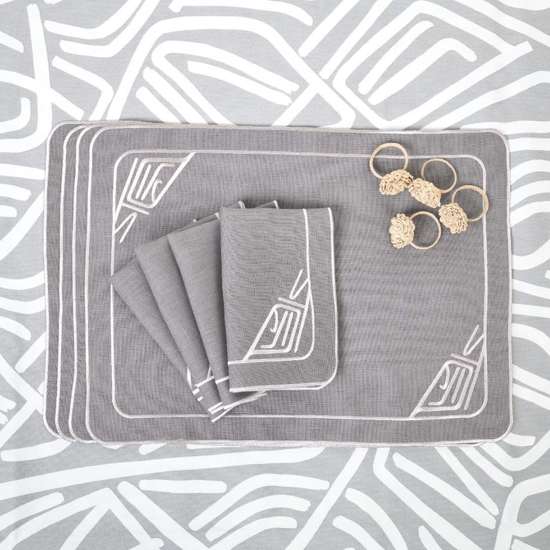 Gray linen placemat embroidered with minalist motif with matching napkins.
