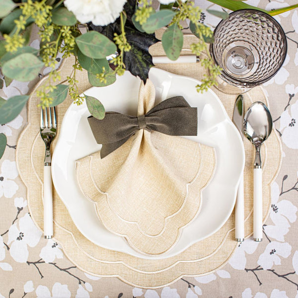 Beige Petali embroidered placemat with petal-shaped edges styled with matching napkin.