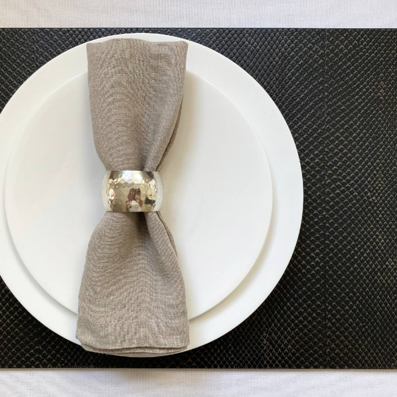 Charcoal faux boa placemat with textured finish in dark brown and grey under white plate.