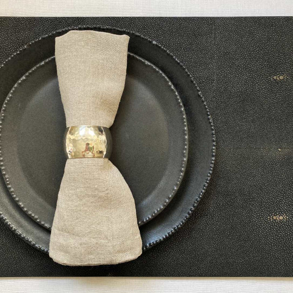 Chocolate brown faux shagreen placemat with hand-polished finish under charcoal plate.