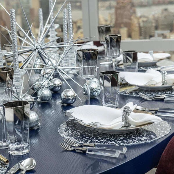 Refined dining table in silver tones featuring Glam Knot napkin rings by Kim Seybert