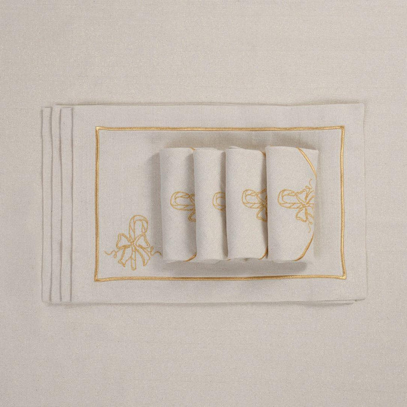 Embroidered candy cane motif detail on gold holiday placemat with matching napkins.