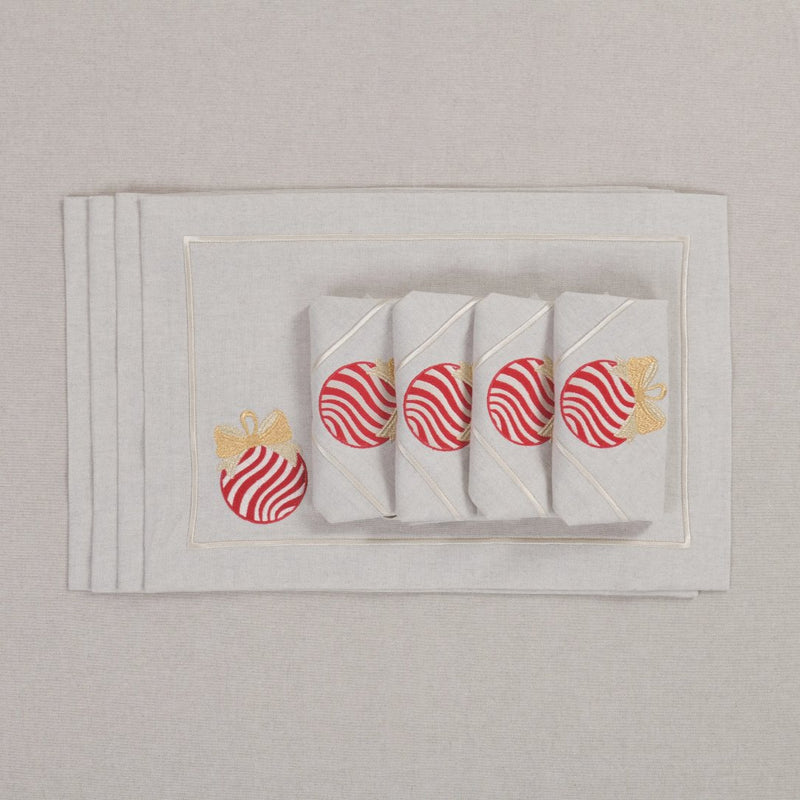 Beige cotton placemat with embroidered Christmas bauble and gold border with matching napkins.