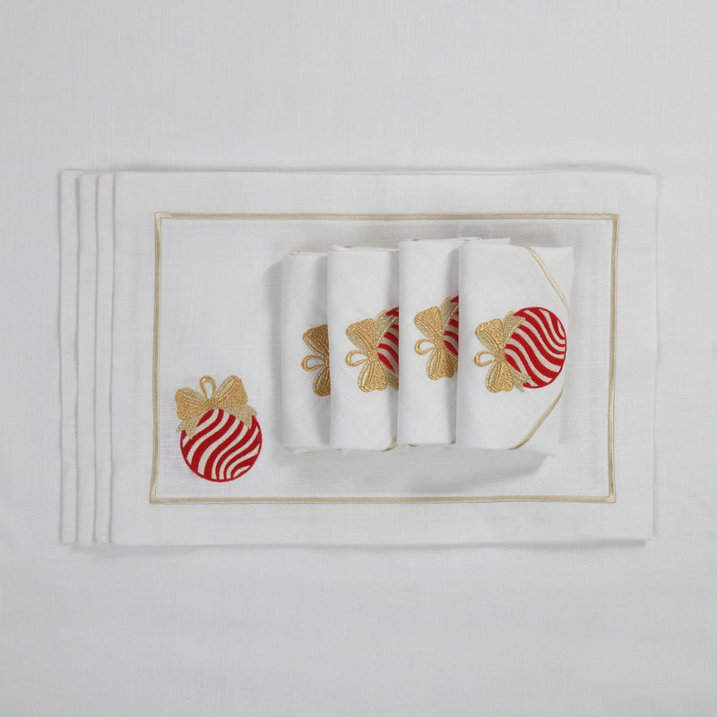 White cotton placemat with embroidered Christmas bauble and gold border with matching napkins.