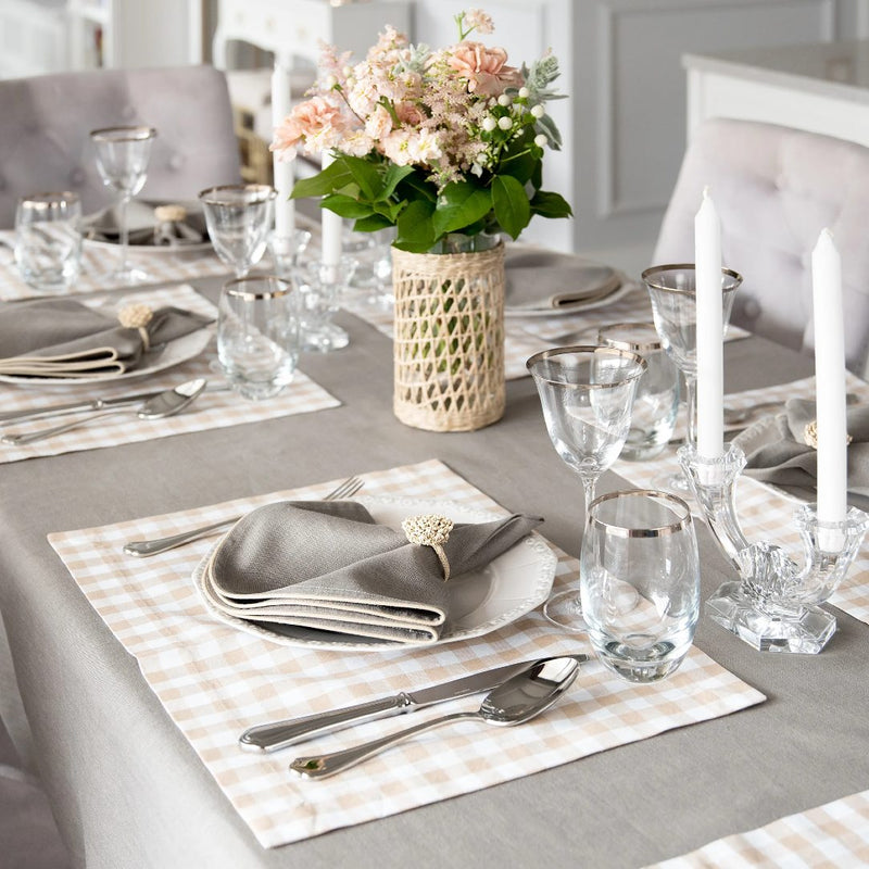 Rectangular beige gingham placemat styled on casual tablescape.