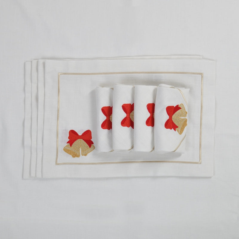White cotton placemat with embroidered Christmas bell and gold border with matching napkins.
