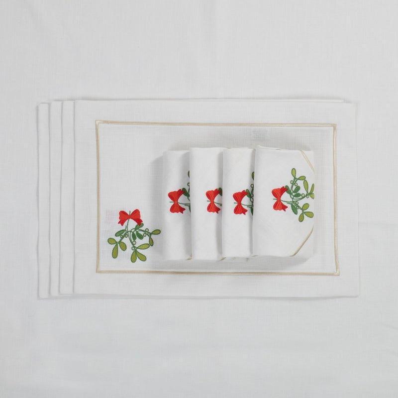 Rectangular white cotton placemat with stitched mistletoe motif with matching napkins.
