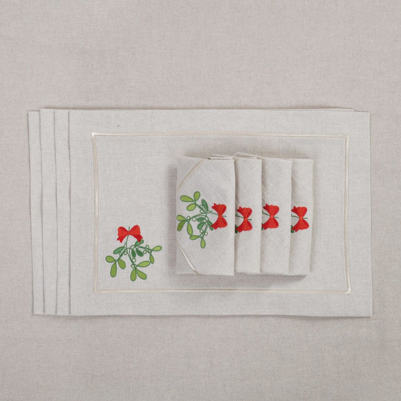 Beige cotton placemat with embroidered mistletoe and gold border with matching napkins.