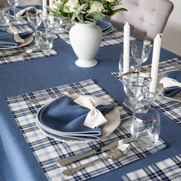 Cotton placemat with navy and light blue plaid side view styled on elegant tablescape.