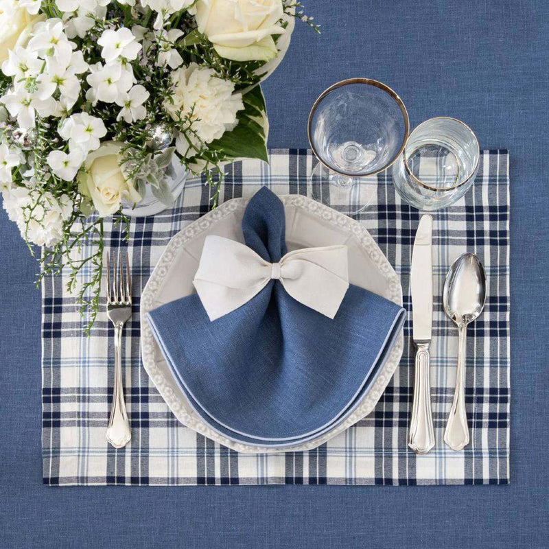 Cotton placemat with navy and light blue plaid styled with white bow napkin ring.