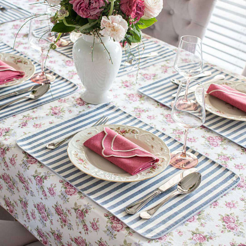Double-sided cotton placemat with rose motif and blue-beige stripes styled on luxury roses tablescape.