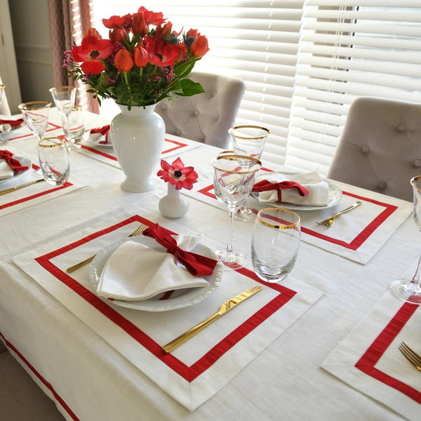 White cotton placemat with red stripe border by Roseberry Home on luxury dinning tablescape.