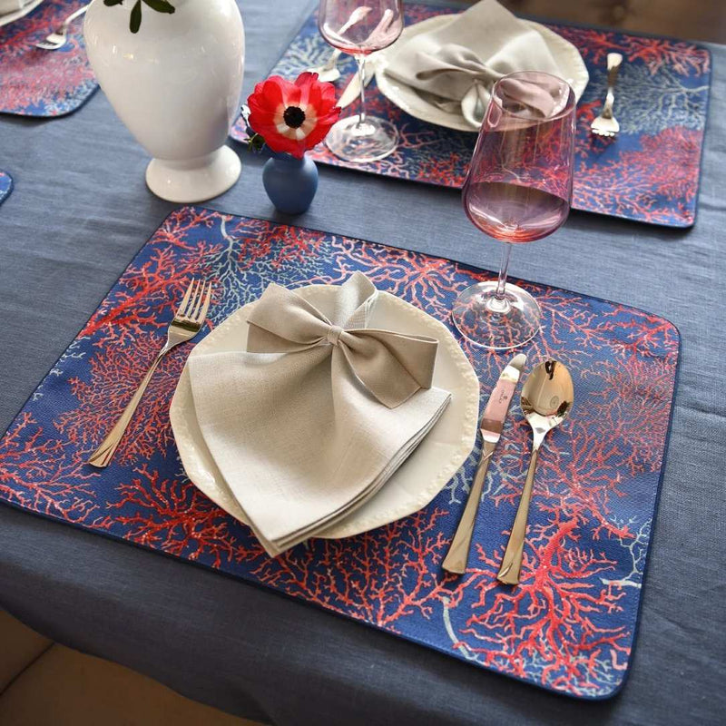 Reversible cotton placemat with seaweed motif and royal blue reverse on elegant luxury tablescape.